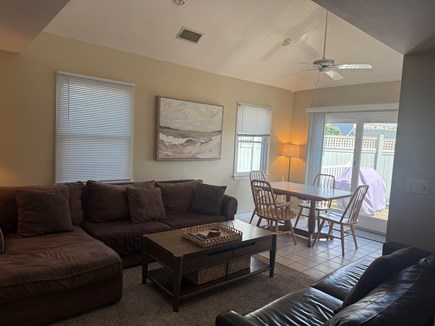 South Yarmouth Cape Cod vacation rental - View of living room and eat in kitchen with slider to patio
