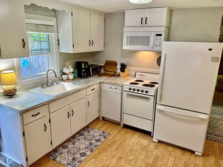 Brewster Cape Cod vacation rental - Bright kitchen with door leading to picnic table and grill.