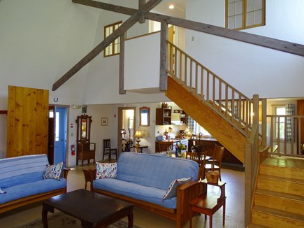 Provincetown Cape Cod vacation rental - Living area showing staircase and entrance to dining/kitchen