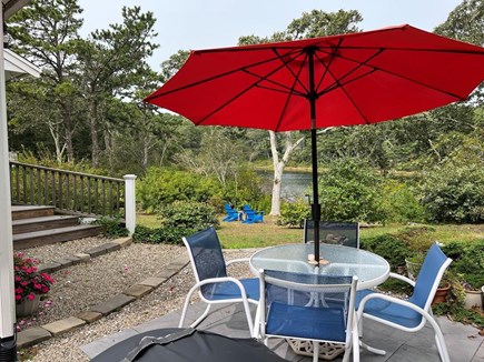 Chatham Cape Cod vacation rental - Corner Patio with water view & 2 blue Adirondack Chairs pond side