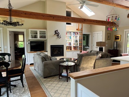 Chatham Cape Cod vacation rental - Living room TV and fireplace, pond view to left