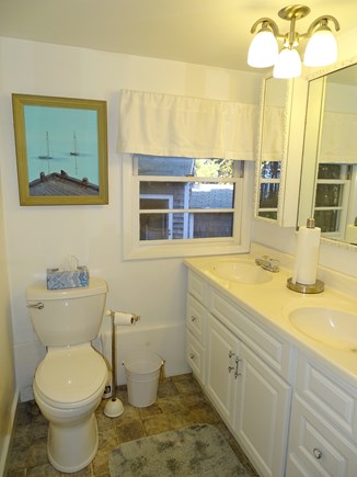 30 7th Street, South Wellfleet Cape Cod vacation rental - Bathroom with shower, double sinks, view of shed in yard