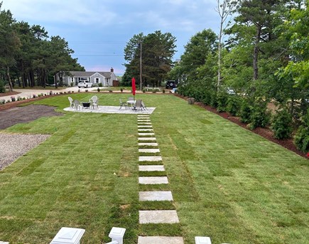 North Eastham Cape Cod vacation rental - Side yard with seating area, facing water