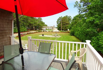 North Eastham Cape Cod vacation rental - Deck off dining room with gas grill, distant water views 