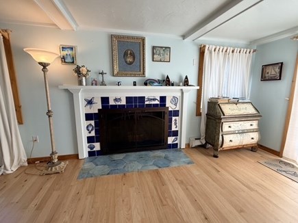 Eastham Cape Cod vacation rental - Main-floor living room with decorative fireplace.