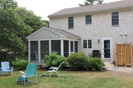 Forest Beach, South Chatham Cape Cod vacation rental - Backyard view of screen porch, deck and new outdoor shower