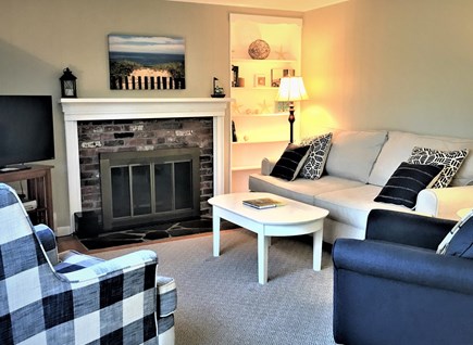  South Harwich Cape Cod vacation rental - Main floor living area with TV, games, access to deck.