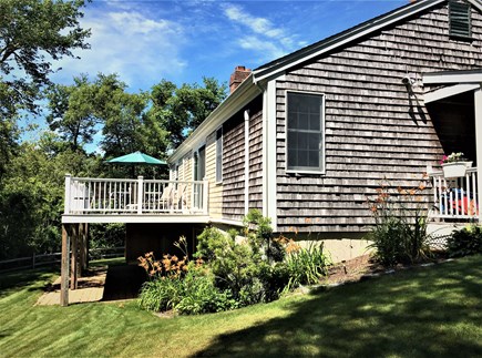  South Harwich Cape Cod vacation rental - Side view of house. Large lawn adjacent to conservation land.