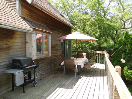 Harwich Cape Cod vacation rental - Deck with grill and dining table, overlooking back yard
