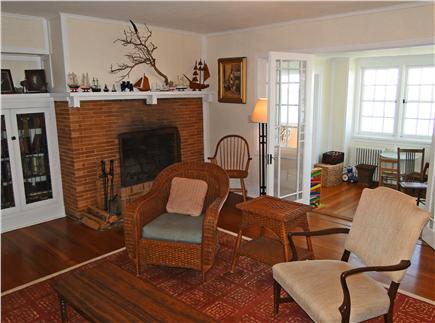 Woods Hole Cape Cod vacation rental - Living room fireplace, showing French doors to sun porch