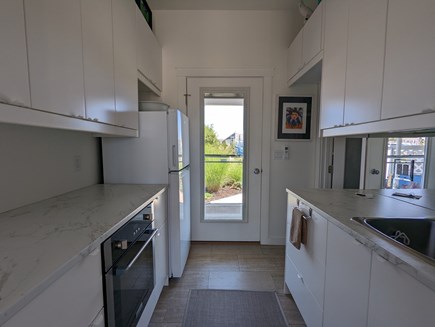 Provincetown Cape Cod vacation rental - Kitchen area with full fridge; wall oven; micro; coffee maker.