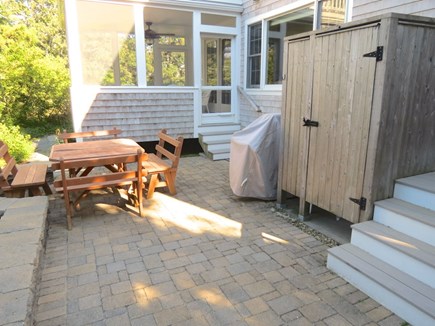 Brewster Cape Cod vacation rental - Patio for dining al fresco.  Note large gas grill next to outdoor shower.  Step up to screened porch.