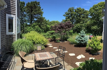 Brewster Cape Cod vacation rental - Side patio and gardens. You have a variety of outdoor living options here.