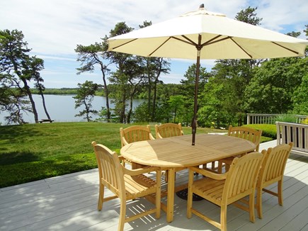Brewster Cape Cod vacation rental - Over-sized deck w/view of pond. Lounges, dining, couch, fire pit.