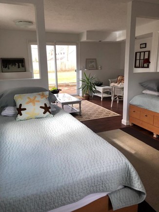 Barnstable, Cummaquid Cape Cod vacation rental - Twin Bedroom with living area and walkout to backyard patio.