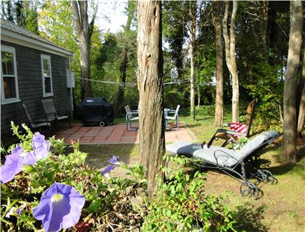 West Dennis Cape Cod vacation rental - Backyard with seating, grill, flowering gardens