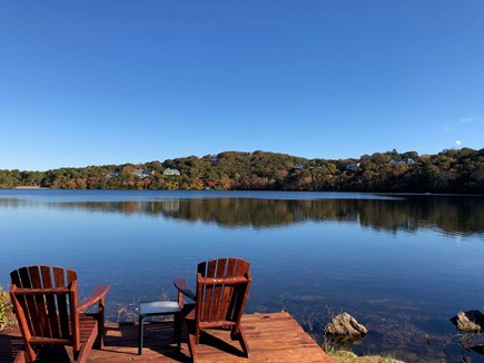 Dennis Village, Scargo Lake Cape Cod vacation rental - Deck at lakefront with Adirondack chairs. Crystal clear water.
