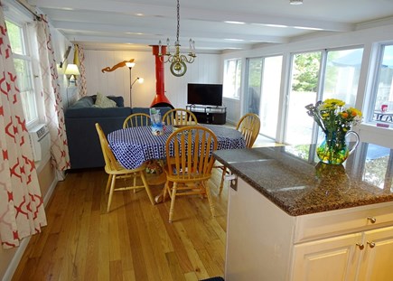 Wellfleet Cape Cod vacation rental - Kitchen leads to living room with TV, two sliders to atrium /deck