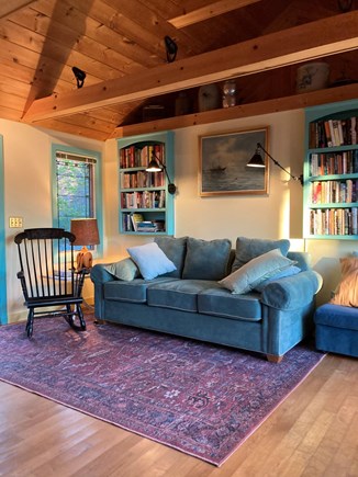 Brewster Cape Cod vacation rental - Living room sofa with reading lamps, books, pond view