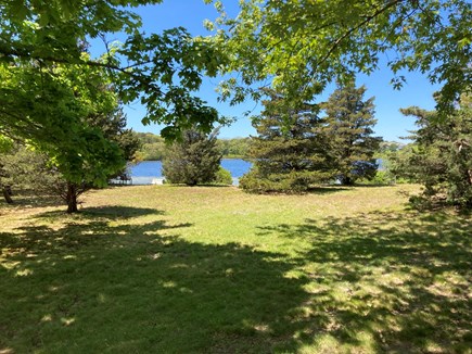 Brewster Cape Cod vacation rental - Backyard patio view, seating pond edge.
