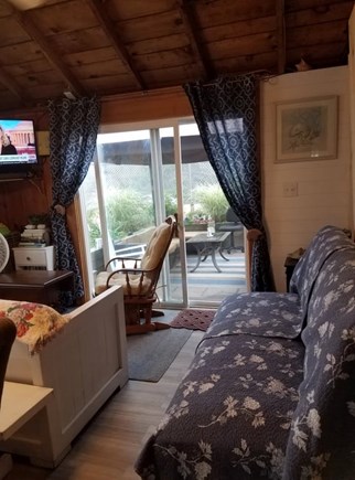 Dennisport Cape Cod vacation rental - Living area open directly onto stone patio with gazebo.
