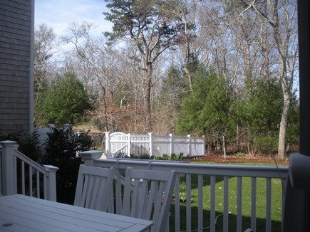 Falmouth Cape Cod vacation rental - View of backyard from back deck. Gated pool are to the left.
