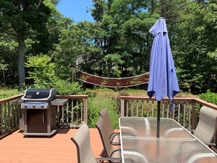 Eastham Cape Cod vacation rental - Large deck overlooks back yard with volleyball and corn hole
