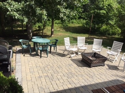 West Hyannisport Cape Cod vacation rental - Paved rear deck with fire pit, tables and chairs. Total privacy.