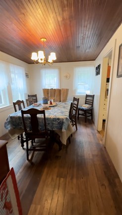 Eastham, Minutes from Campground Beach! Cape Cod vacation rental - Main House Dining Room, stocked with serving dishes, plates.