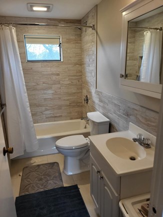 Dennisport... 3/4 mi to Sound  Cape Cod vacation rental - Modern bath with shower and tub with a stool for the wee ones.
