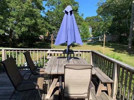 Eastham Cape Cod vacation rental - Sunny back yard with volleyball and corn hole tables.