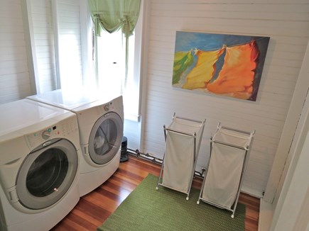 Brewster Cape Cod vacation rental - Main level laundry room.  Note the colorful choice of wall art.