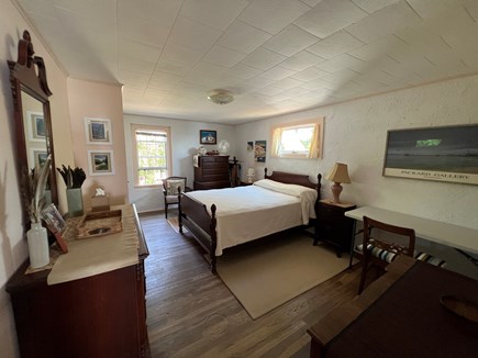North Truro Cape Cod vacation rental - Master bedroom with half bath overlooking garden