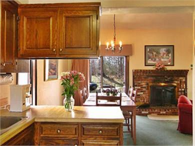 Brewster Cape Cod vacation rental - View from kitchen to living/dining area & sliders to deck