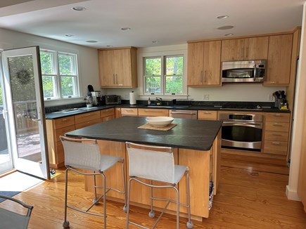 Wellfleet Cape Cod vacation rental - Open dining (obscured), well-appointed kitchen opening onto deck