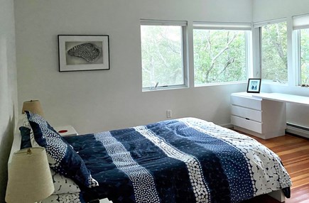 Wellfleet Cape Cod vacation rental - Master bedroom with queen bed, workspace and view of woods.