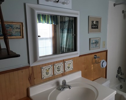 Nauset Heights (East Orleans) Cape Cod vacation rental - lst fl. Bathroom. Tub/shower combo, vanity storage, sunny window.
