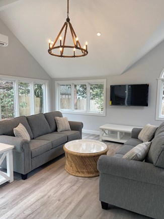 Harwichport Cape Cod vacation rental - Great room with table and TV.