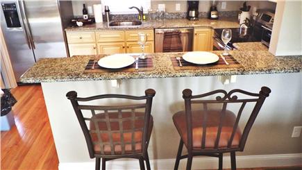 West Harwich Cape Cod vacation rental - View of kitchen from barstools