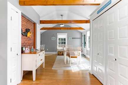 Brewster Cape Cod vacation rental - Another view of the dining area off the kitchen. Washer/dryer behind the bi-fold doors.