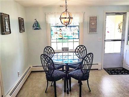 South Yarmouth Cape Cod vacation rental - Eat-in kitchen. Front porch with glider bench outside the door.