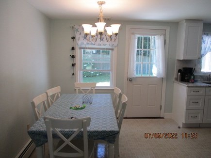 Hyannis/Craigville Cape Cod vacation rental - Kitchen dining area with backyard/deck access.