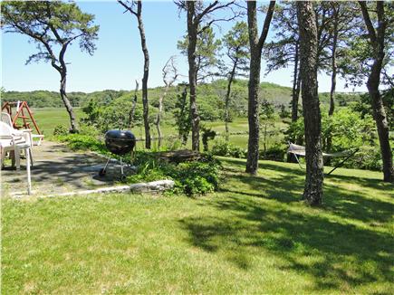 South Chatham Cape Cod vacation rental - Back yard area faces water with grill, lounging chairs, hammock.