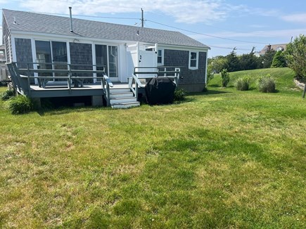 West dennis Cape Cod vacation rental - Large grassy backyard, deck and outside shower.
