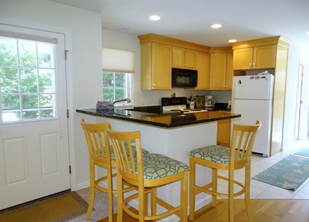 eastham Cape Cod vacation rental - Kitchen offers breakfast bar, door to back deck 