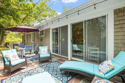 Harwich Port Cape Cod vacation rental - Unwind in style with cushioned loungers and a garden view