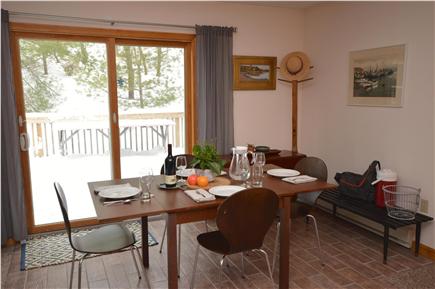 Truro Cape Cod vacation rental - Dining area with slider leading to large deck and gas grill.