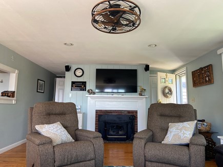 Yarmouth Port Cape Cod vacation rental - Swivel rocker recliners and wood stove in the living room.