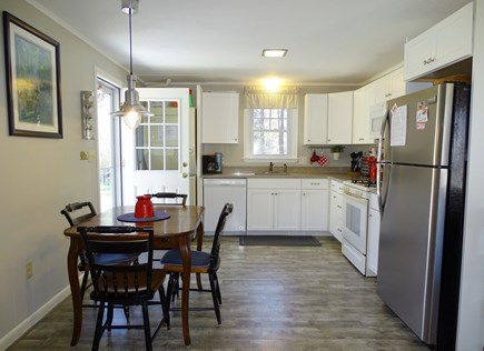 Eastham Cape Cod vacation rental - Kitchen view from living area, with side door to patio