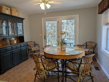 West Hyannis Cape Cod vacation rental - Kitchen dining area opens to side deck with grill & dining table